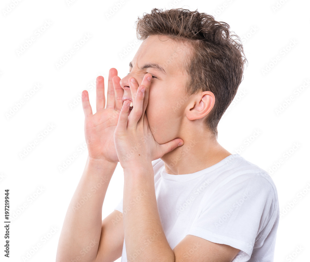 Emotional portrait profile of angry teen boy in white t-shirt. Child screaming with wide open mouth, isolated on white background. Negative human face expression. Conflict concept. Emotional portrait profile of angry teen boy in white t-shirt. Child screaming with wide open mouth, isolated on white background. Negative human face expression. Conflict concept.