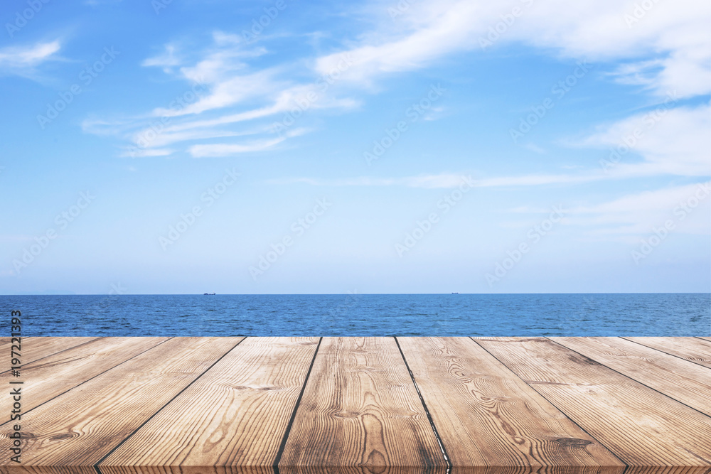 Wooden table with seascape background