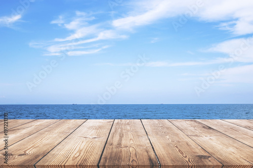 Wooden table with seascape background