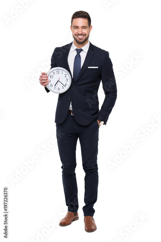 Young stylishg businessman with teeth smile holding clock isolated