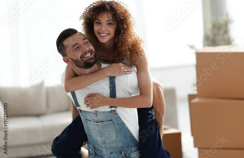 wife hugs her husband in a new apartment.