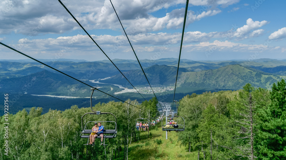 Chairlift up to the top of mountain on sunny summer day