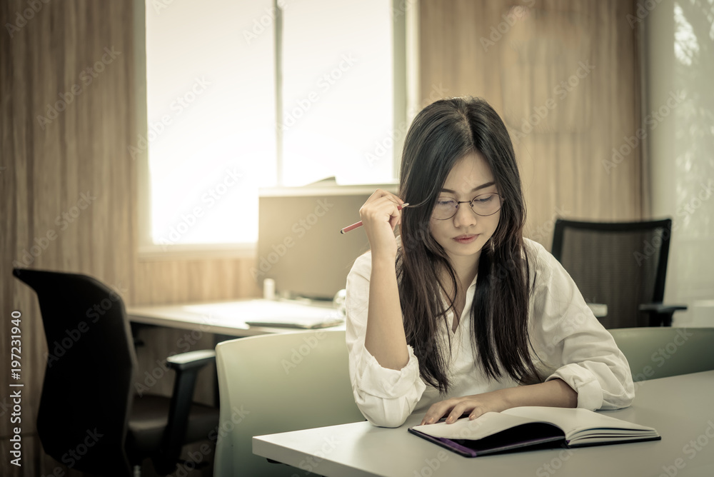 Close up sad woman in the office,stress girl from hard work,Thailand serious Women think about work. Close up sad woman in the office,stress girl from hard work,Thailand serious Women think about work.