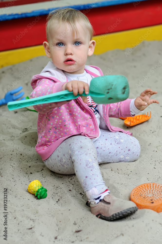 Fototapeta premium Small child in sandbox outdoors