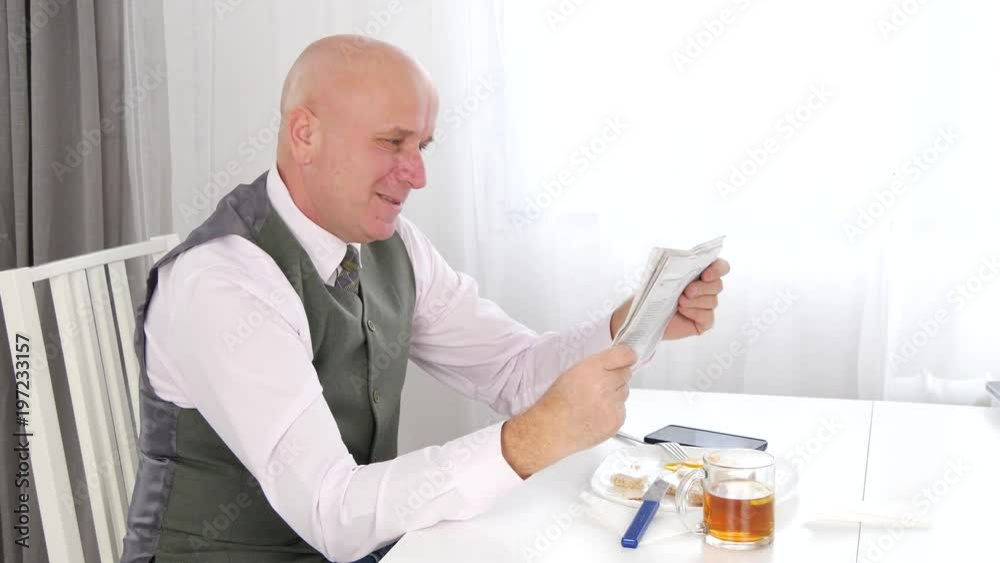 Enthusiastic Businessperson Gesturing Happy After He Read Good News in Gazette Enthusiastic Businessperson Gesturing Happy After He Read Good News in Gazette