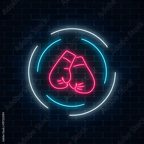 Glowing neon boxing club sign in circle frame on dark brick wall background. Fighting club neon signboard.
