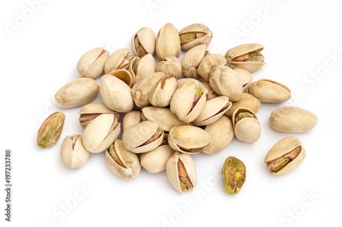 group of green pistachios and their husks