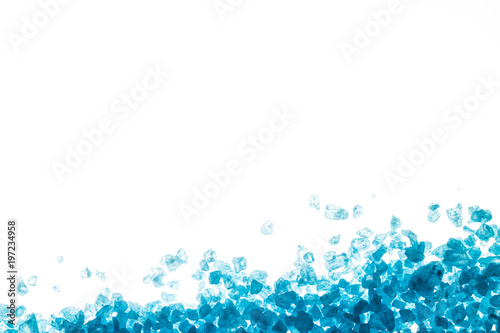Blue crystals of sea salt on white background