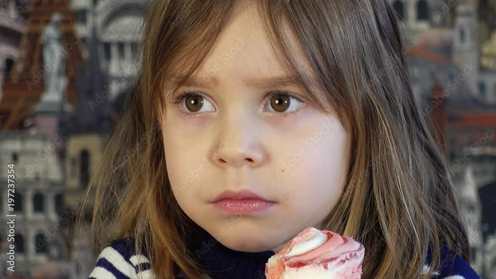 A small child, a charming girl 4-5 years old, eats ice cream. A small child, a charming girl 4-5 years old, eats ice cream.