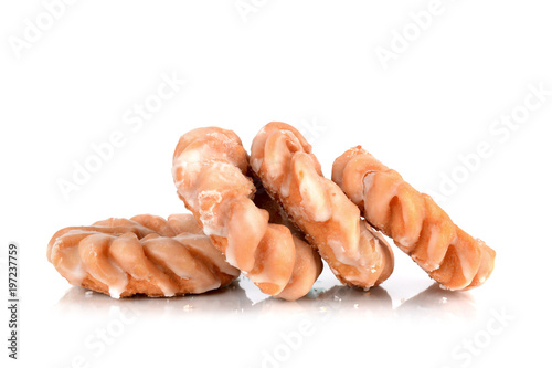 Four cruller donuts in pile isolated white background 
