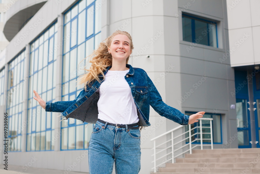 Girl, jeans and jacket, fun, close up, building background Girl, jeans and jacket, fun, close up, building background