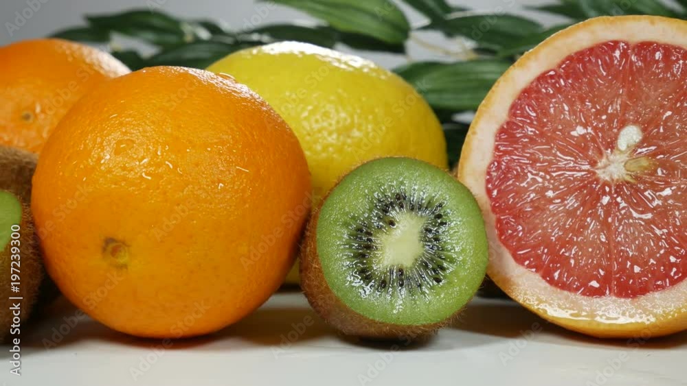 Beautiful, juicy and fresh fruit on the table for presentation. Oranges, greyfruits, lemons, kiwi. Beautiful, juicy and fresh fruit on the table for presentation. Oranges, greyfruits, lemons, kiwi.