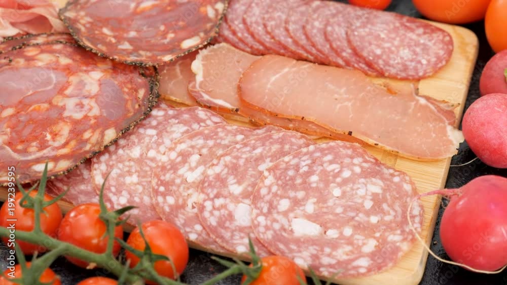 Antipasto meat appetizers on wooden board Antipasto meat appetizers on wooden board