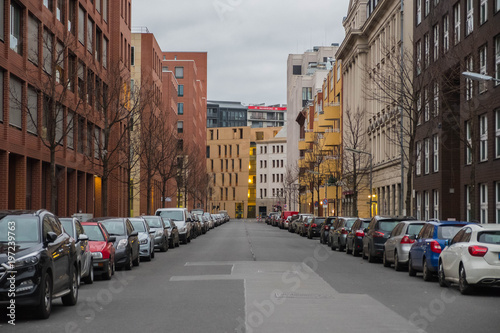Berlin. Germany. A city street with parked cars on either side of the sidewalk