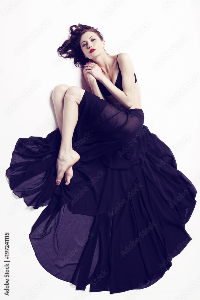 Studio shot of gorgeous young woman in elegant dress Studio shot of gorgeous young woman in elegant dress