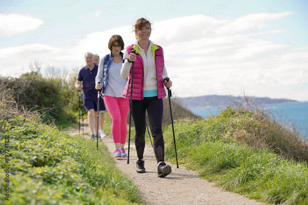 Senior people nordic walking by the atlantic coast