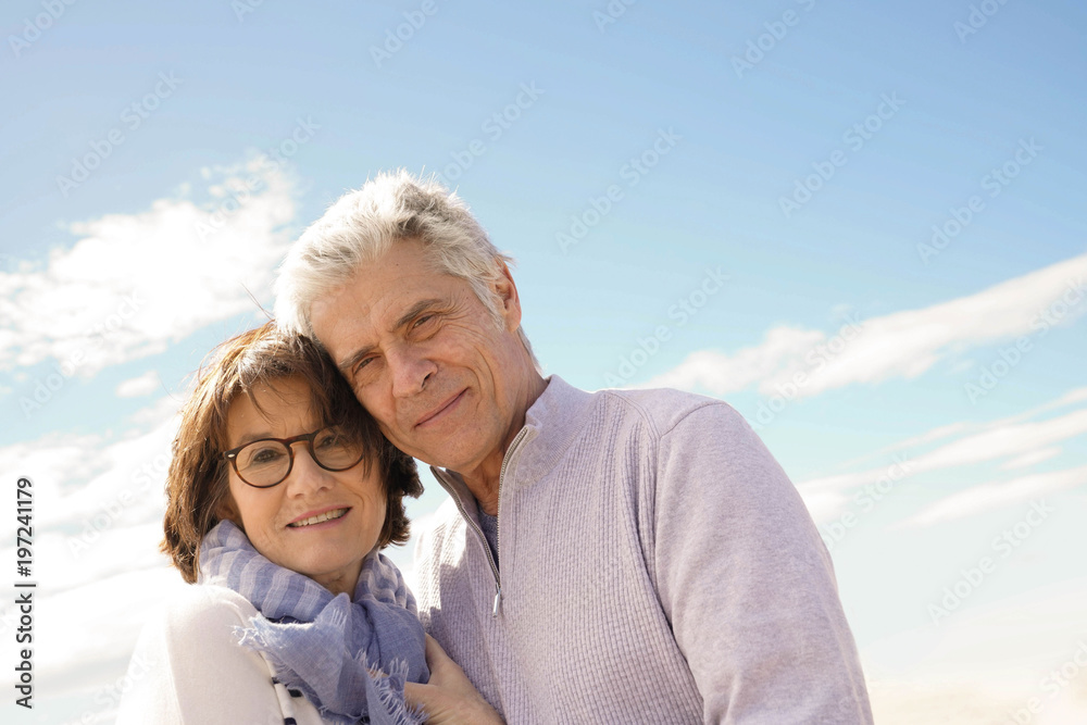 Portrait of senior couple embracing by the beach