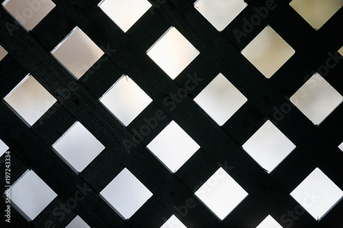 Geometric background with squares. Black wooden grille