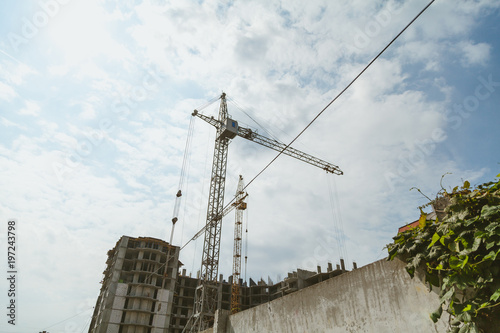 Lifting tower cranes on frame of frame building