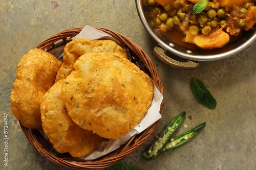 Canvastavla Indian Masala Poori / Puri served with Aloo Mutter , selective focus
