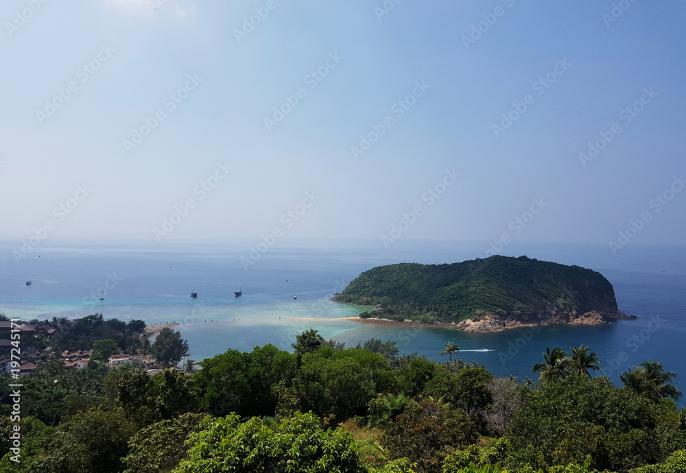 Image of coastal zone with trees against backdrop of hills