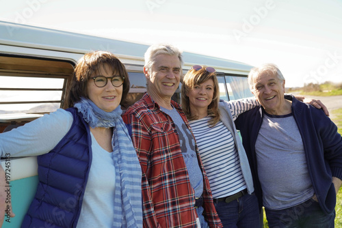 Senior people on a road trip with camper van enjoying stop in countryside