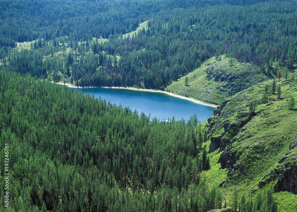 Mountain lake surrounded by forest in Altai, Russia Mountain lake surrounded by forest in Altai, Russia