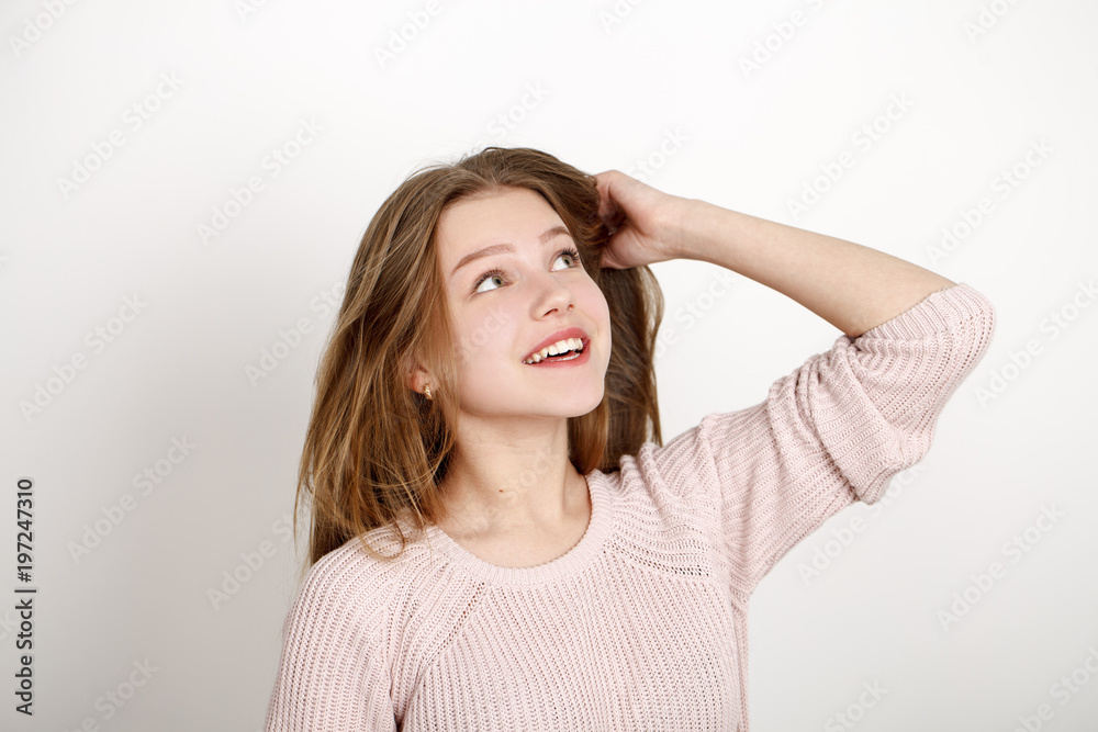 Close up portrait of pretty young schoolgirl with dark blonde hair smiling charmingly Close up portrait of pretty young schoolgirl with dark blonde hair smiling charmingly