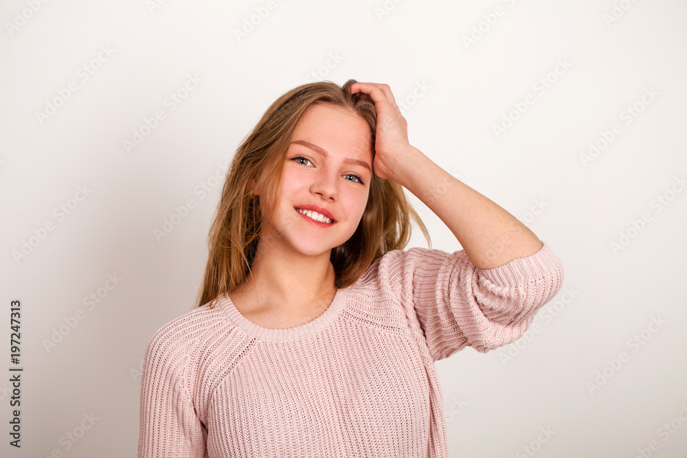 Close up portrait of pretty young schoolgirl with dark blonde hair smiling charmingly Close up portrait of pretty young schoolgirl with dark blonde hair smiling charmingly