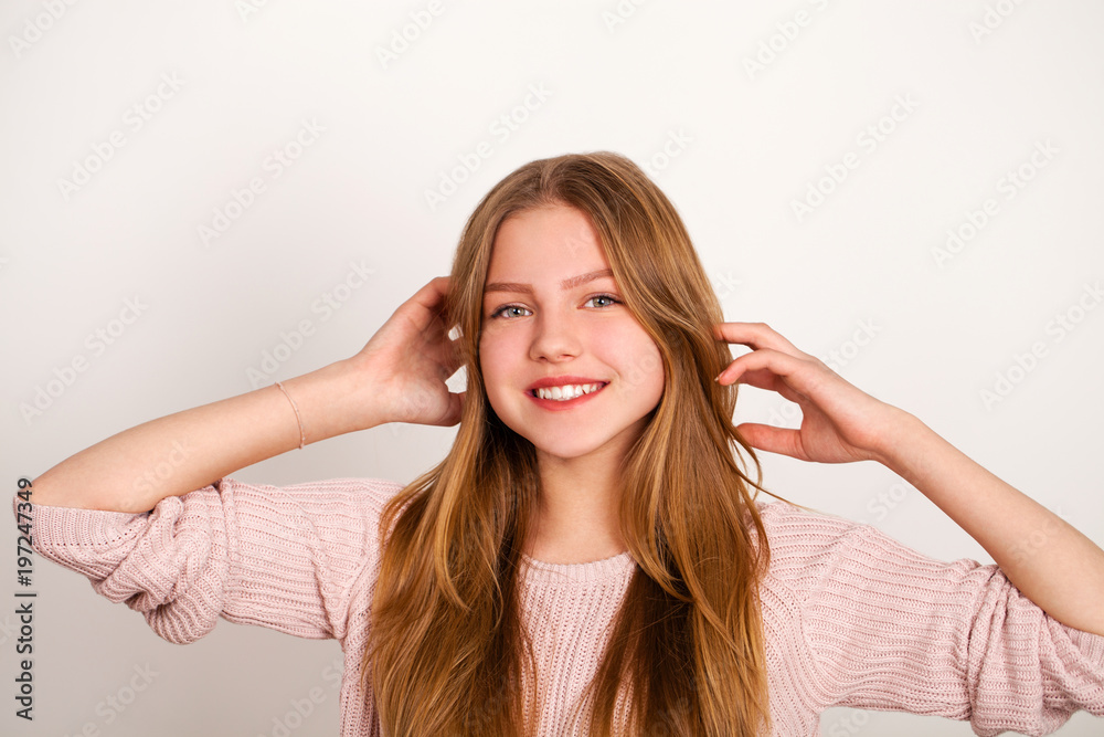 Close up portrait of pretty young schoolgirl with dark blonde hair smiling charmingly Close up portrait of pretty young schoolgirl with dark blonde hair smiling charmingly