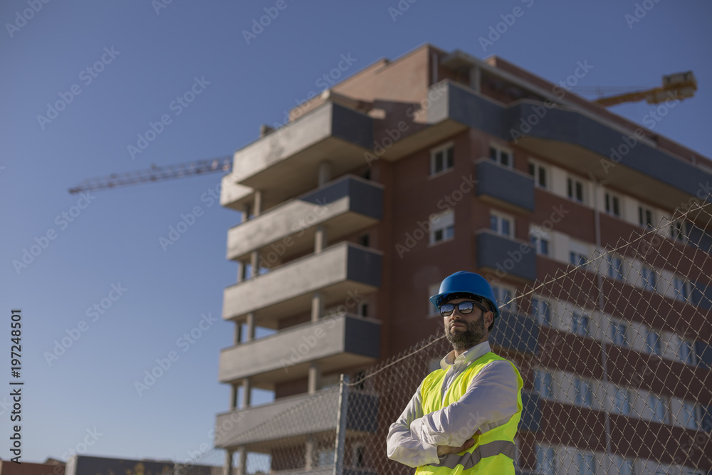Architect or Engineer on the Construction Site. Daytime. Wearing protection equipment