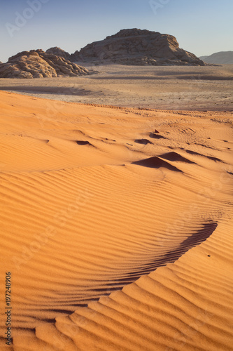 sand dune and view to mountains in desert Wadi Rum in Jordan
