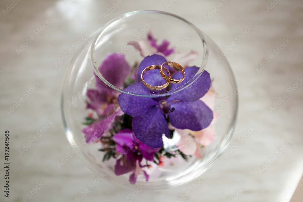 Wedding rings on the petal of purple orchid Wedding rings on the petal of purple orchid