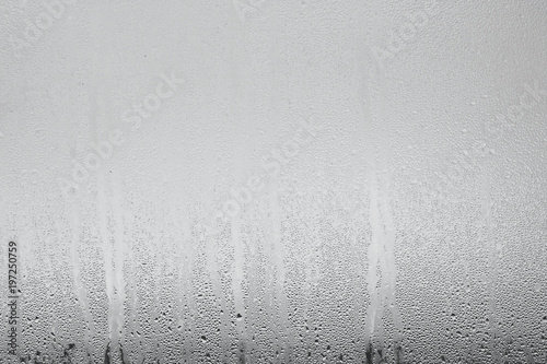 Obraz na plátně Blue background of natural water condensation, window glass with high air strong humidity, large drops drip