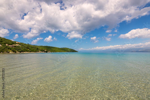 Crystal sea water, summer scenic view of Apras bay near Kassiopi on Corfu island in Greece.