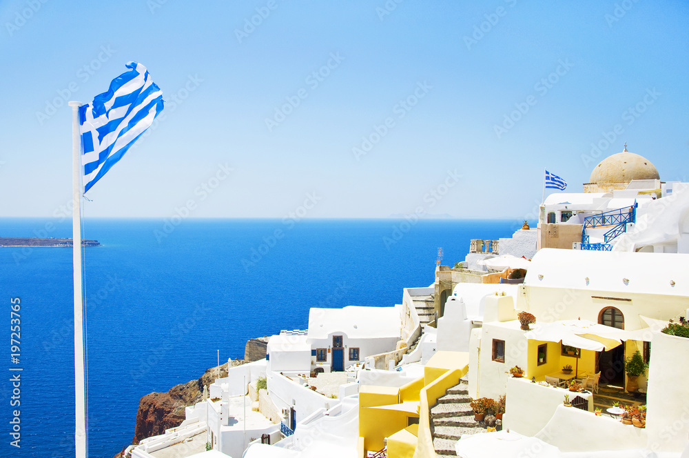 Obraz premium View of the village of Oia, Santorini, Greece. Traditional Greek architecture, white houses, the Aegean Sea, the caldera. White architecture against the blue sea