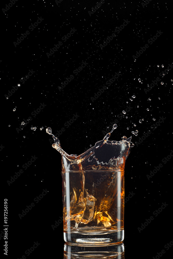 Whiskey splash isolated on black background