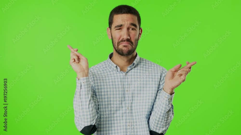 Hopeful young man against green background Hopeful young man against green background