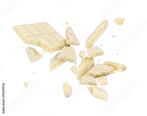 White porous chocolate broken into pieces in the air, isolated on a white background