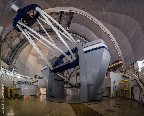 Huge modern professional astrophysical telescope under dome of observatory