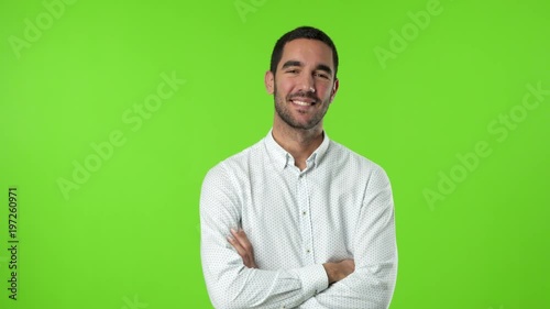 Satisfied young man against green background