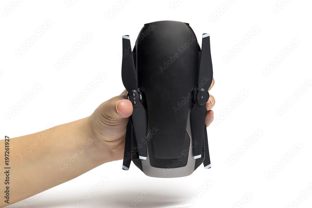 Naklejka premium drone assembled quadrocopter in hand on a white background