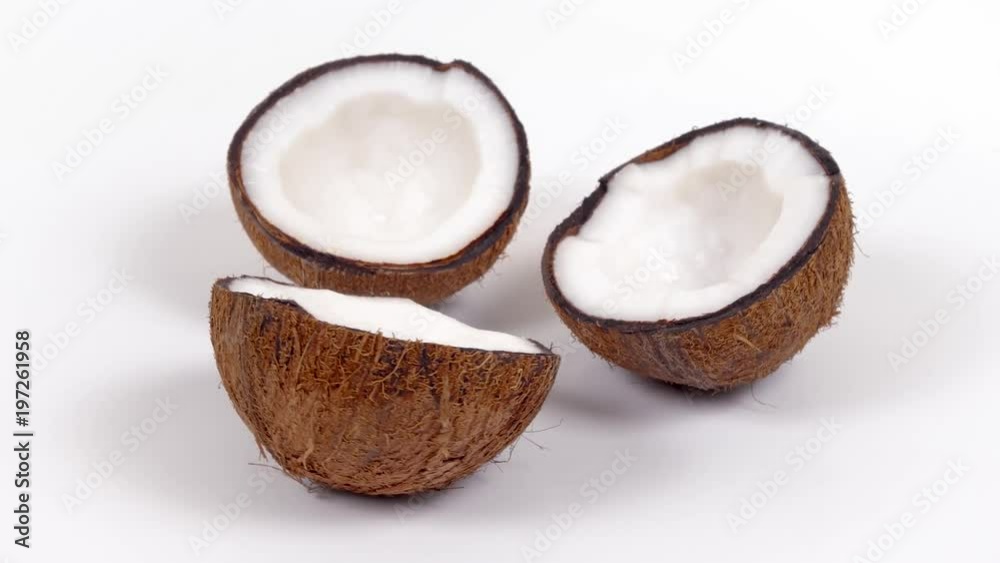 Three ripe tropical coconut halves with yummy white pulp rotating on white isolated background. Healthy fresh tropical fruits. Loopable seamless cocos rotating Three ripe tropical coconut halves with yummy white pulp rotating on white isolated background. Healthy fresh tropical fruits. Loopable seamless cocos rotating