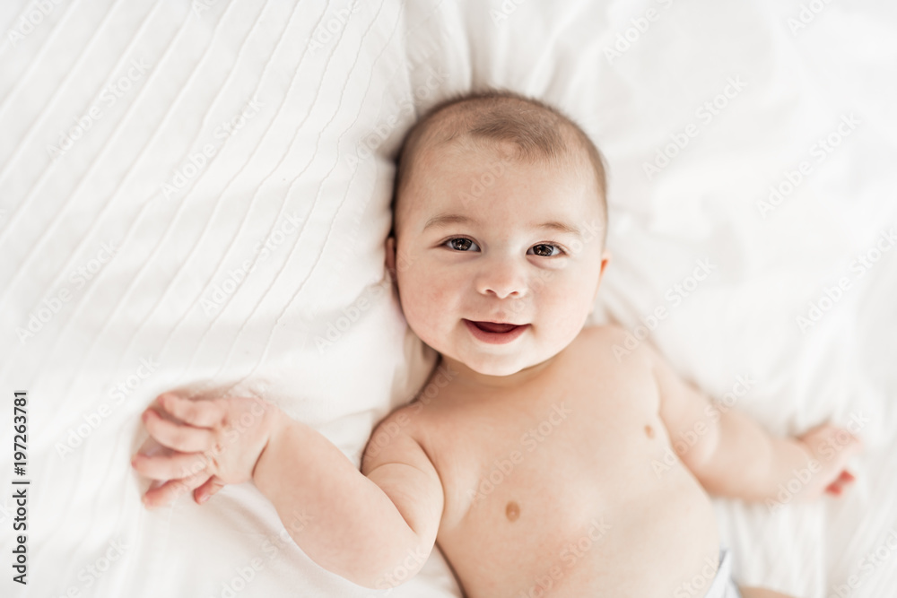 Portrait of a baby boy on the bed in bedroom Portrait of a baby boy on the bed in bedroom