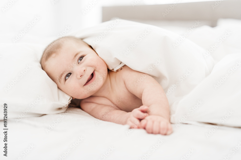 Portrait of a baby boy on the bed in bedroom Portrait of a baby boy on the bed in bedroom