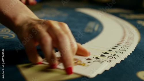 Casino: Dealer woman shuffles the poker cards and performing trick with cards. Shot on RED EPIC DRAGON Cinema Camera in slow motion.