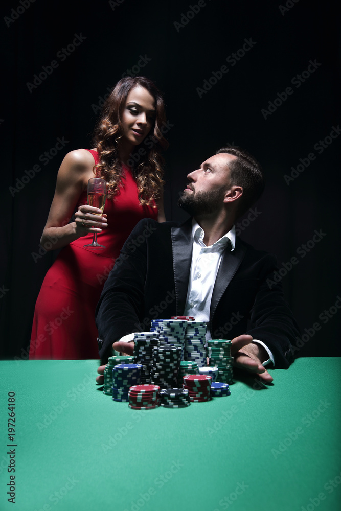 woman and man at the poker table with chips and drinks woman and man at the poker table with chips and drinks