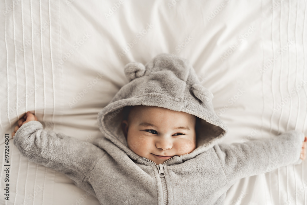 Portrait of a baby boy on the bed in bedroom Portrait of a baby boy on the bed in bedroom