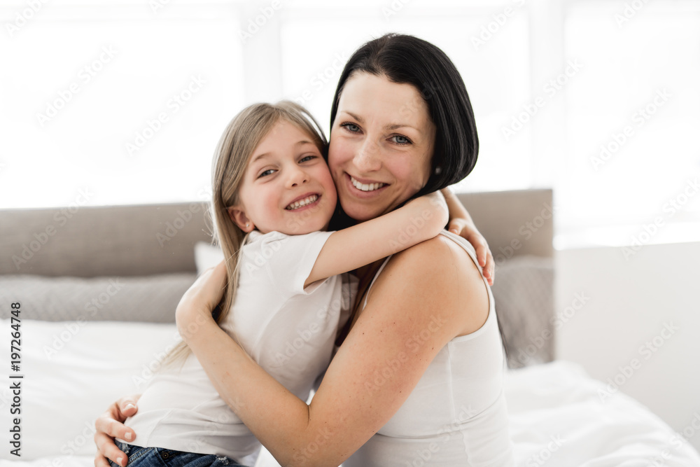 Mother and daughter enjoy in bed at home Mother and daughter enjoy in bed at home