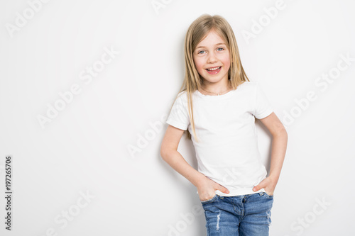 Happy small five years old girl with straight hair over white background at home